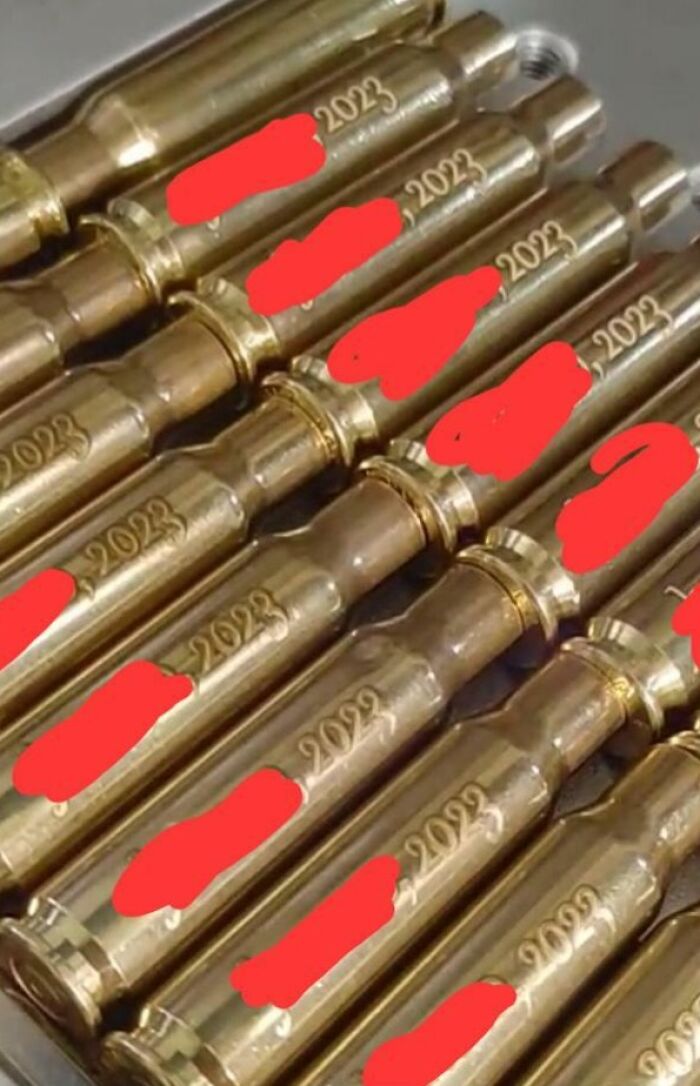 Wedding Favors Are Engraved Bullet Casings With The Date And The Couples' Names On Them