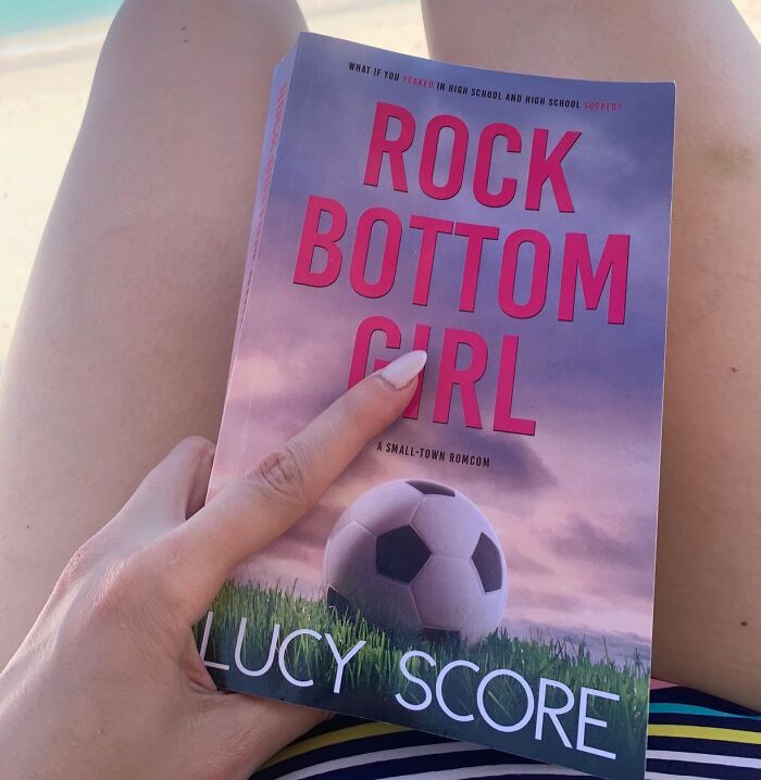  "Rock Bottom Girl" By Lucy Score: A Fake Dating Trope With A Grumpy Hero And A Sunshine Heroine Who's Coaching The Losing-Est Girls' Soccer Team In History? This Ain't Your Average Underdog Story – It's A Hilarious And Heartwarming Ride That'll Leave You Cheering From The Sidelines