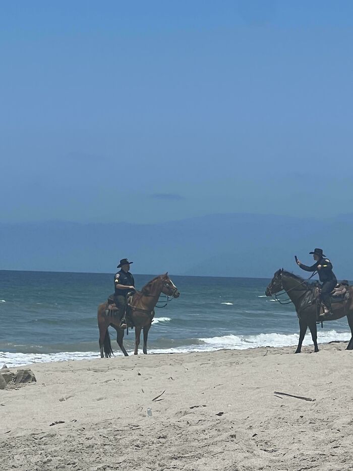 Mounted Police Taking Pictures At The Beach