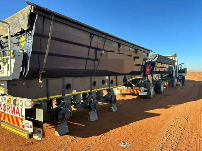 Truck incident on a dirt road without wheels, likely an expensive mistake.