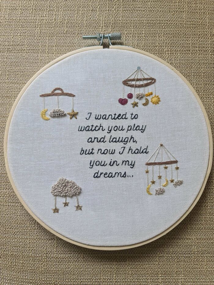 Creative embroidery piece featuring hanging stars and a heartfelt message in a hoop.