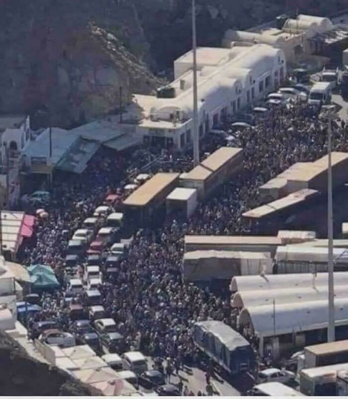 Aerial view of traffic jam and crowded street, suggesting a boring dystopia.