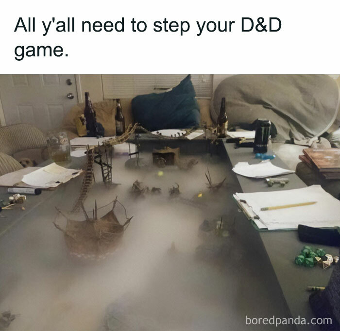 A DnD meme showcasing an elaborate tabletop game setup with detailed terrain, miniature bridges, and buildings, surrounded by a misty fog effect. The text above the image reads, "All y'all need to step your DnD game." This meme humorously suggests that players should enhance their DnD sessions with more immersive and creative setups.