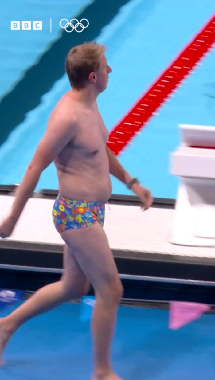 Man With “Dad Bod” And Snug Speedos Hailed A Legend For Keeping “The Olympics From Falling Apart”