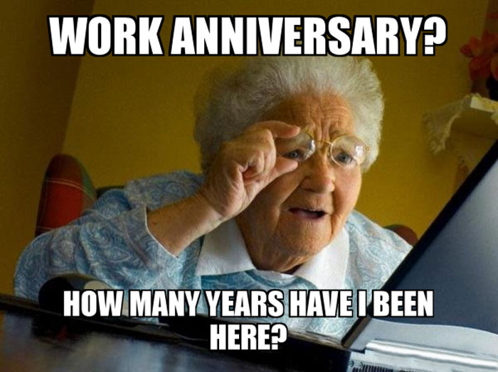 Elderly woman squinting at a laptop with the caption: 'WORK ANNIVERSARY? HOW MANY YEARS HAVE I BEEN HERE?' The meme humorously depicts confusion about the length of time spent at a job.