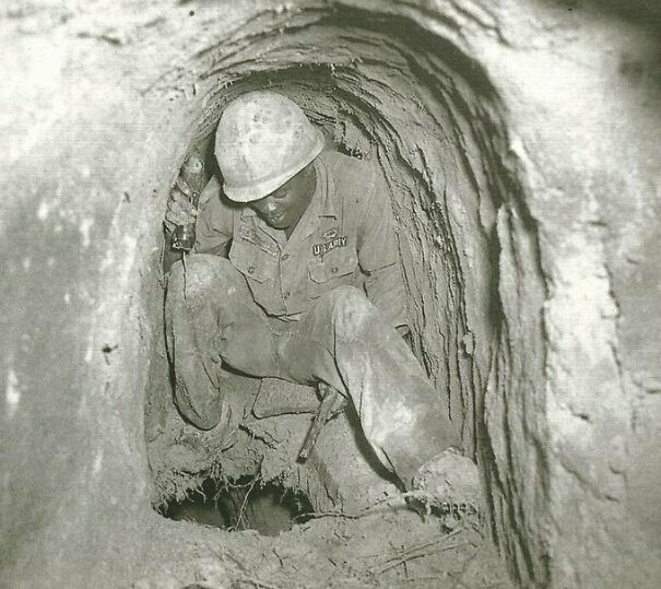 A Tunnel Rat Explores A Hole Between “Floors” Of A Viet Cong Tunnel System