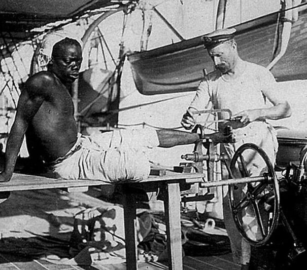 In 1907, A British Sailor Is Seen Unshackling An Enslaved Man Who Had Been Chained For Three Years