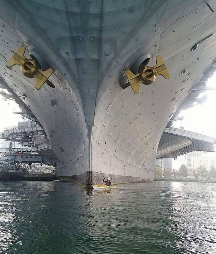 The Size Of The USS Midway Compared To A Man In His Kayak Is Astounding