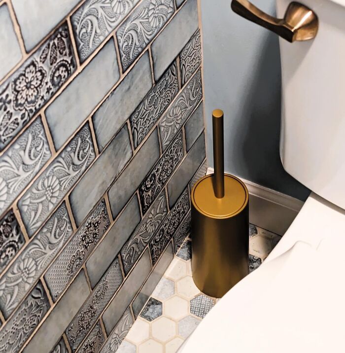 Upgrade your bathroom aesthetics with a simple swap! Ditch the unsightly plastic toilet brush holder and opt for a stylish glazed ceramic or enamel jug. It's a subtle change that elevates your bathroom decor while keeping your toilet brush discreetly tucked away.