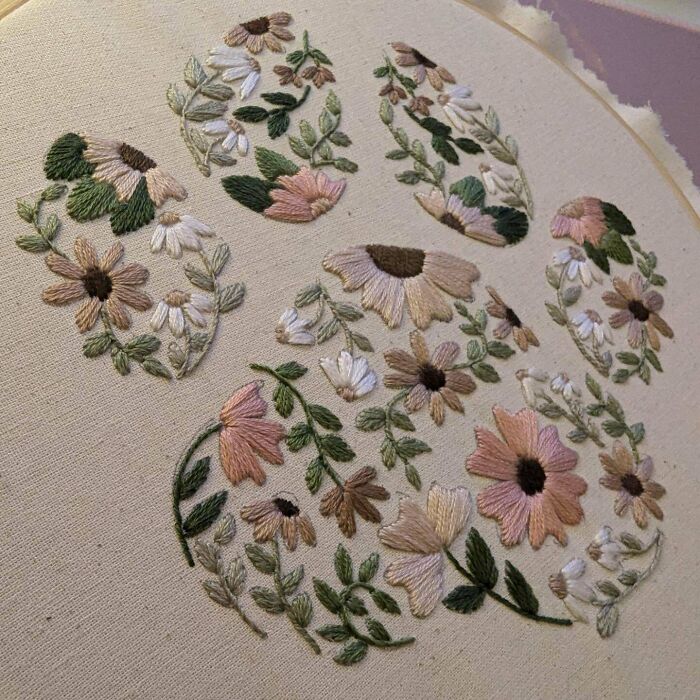 Creative floral embroidery design on fabric showcasing intricate needlework and pastel colors.