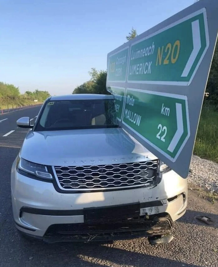 SUV crashed into road sign, likely expensive damage.