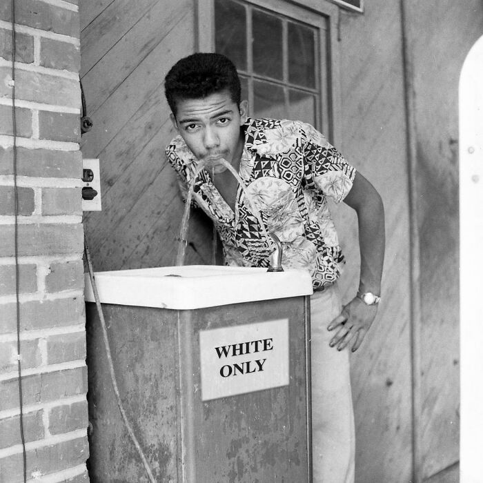 A Black Man Drinking From A White Only Fountain In 1956