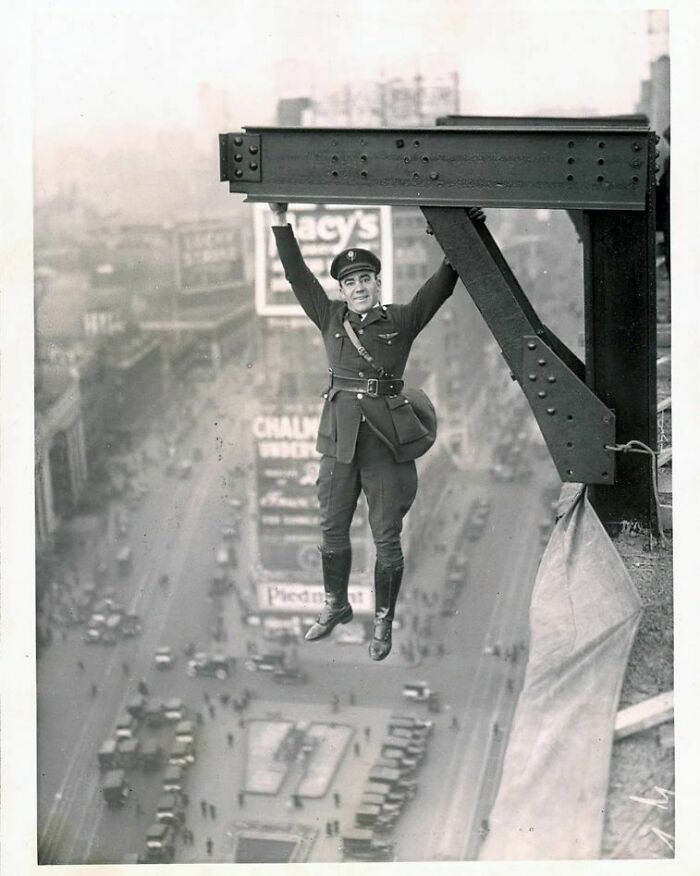 Un miembro de la policía de Nueva York cuelga de una viga, 1920