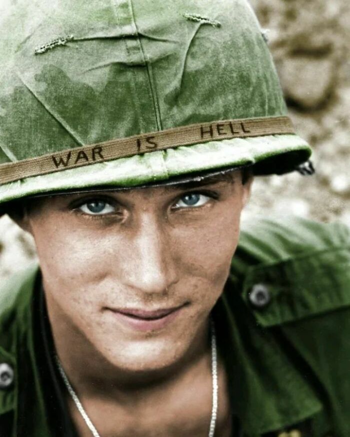 An American Soldier Wears A Hand Lettered “War Is Hell” Slogan On His Helmet, Vietnam, 1965