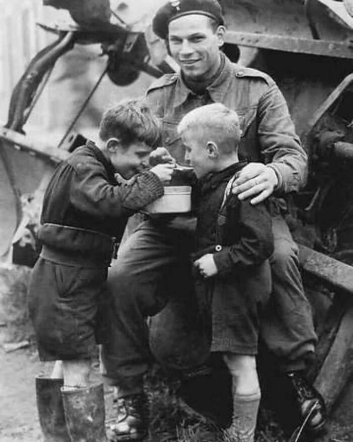 A Soldier Shares His Food With Two Dutch Kids, 1945