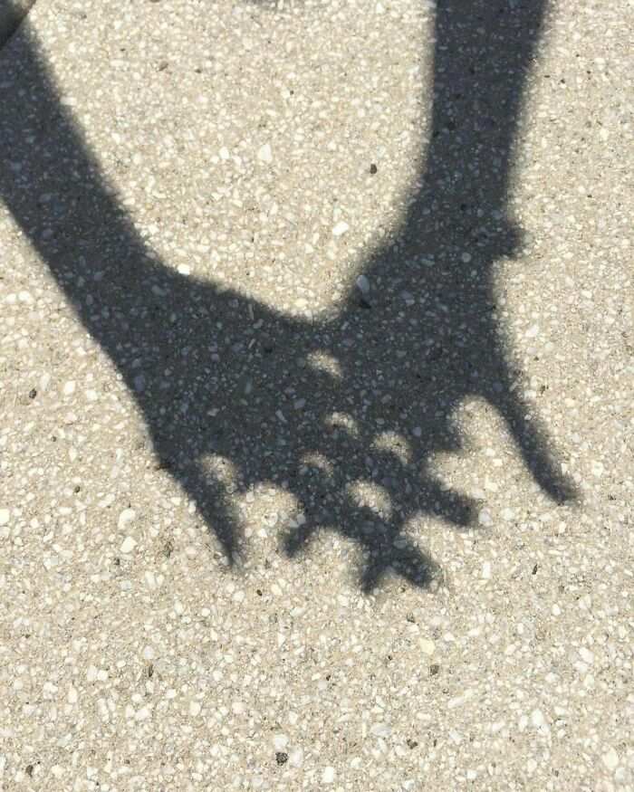 The Shadow Of An Eclipse Can Be Seen Through The Bumps In Between Your Fingers. This Is An Alternative Way To View A Solar Eclipse Without Frying Your Retinas