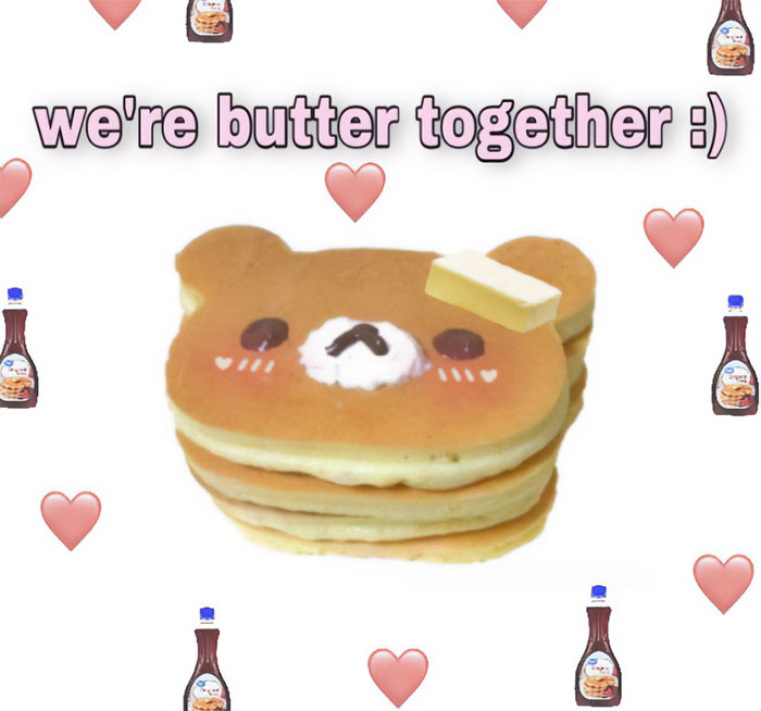 A love meme featuring a stack of pancakes shaped like a bear's face with a pat of butter on top. The text above the image reads, "we're butter together :)" The background is filled with small heart icons and bottles of syrup.