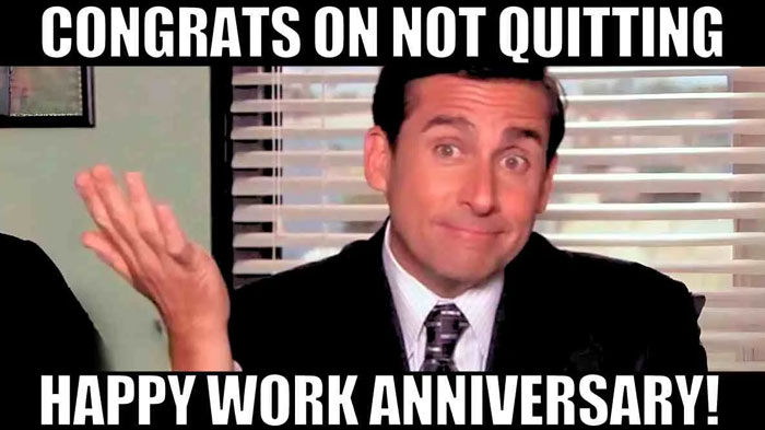 A work anniversary meme featuring Michael Scott, a character from the TV show The Office, with a shrugging gesture and an expression of mild surprise. The text at the top reads, "CONGRATS ON NOT QUITTING," and the text at the bottom says, "HAPPY WORK ANNIVERSARY!" The meme humorously acknowledges the achievement of staying at a job for another year with a mix of sarcasm and encouragement.