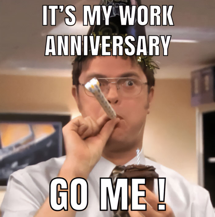 A work anniversary meme featuring a character from the TV show The Office, Dwight Schrute, wearing a party hat and blowing a party horn while holding a cupcake. The text above reads, "IT’S MY WORK ANNIVERSARY," and the text below says, "GO ME!" The meme humorously celebrates a work anniversary with Dwight's character, known for his quirky personality, making the celebration feel both enthusiastic and self-congratulatory.