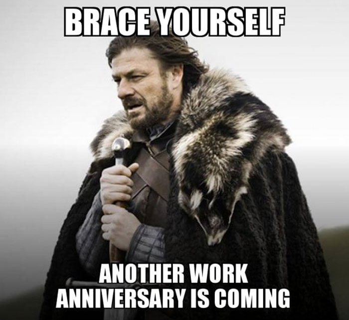 A Work Anniversary meme featuring a character dressed in medieval-style armor and fur cloak, holding a sword, with a serious expression. The text above the image reads, "Brace yourself," and below, it says, "Another work anniversary is coming." The meme humorously implies that a work anniversary is an event to prepare for, playing on the iconic "brace yourself" phrase.