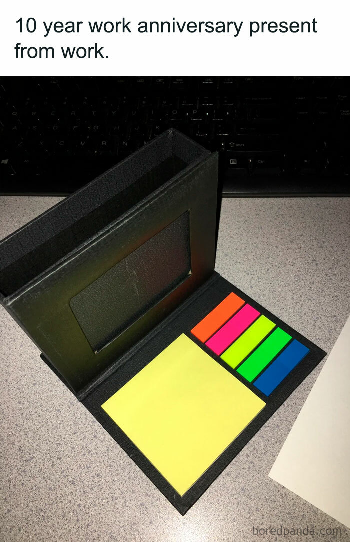 A work anniversary meme showing a small gift set of sticky notes and colorful page markers inside a black holder. The text above the image reads, "10 year work anniversary present from work." The image humorously comments on the modest and somewhat disappointing nature of the gift, considering it is meant to celebrate a decade of service at the company.