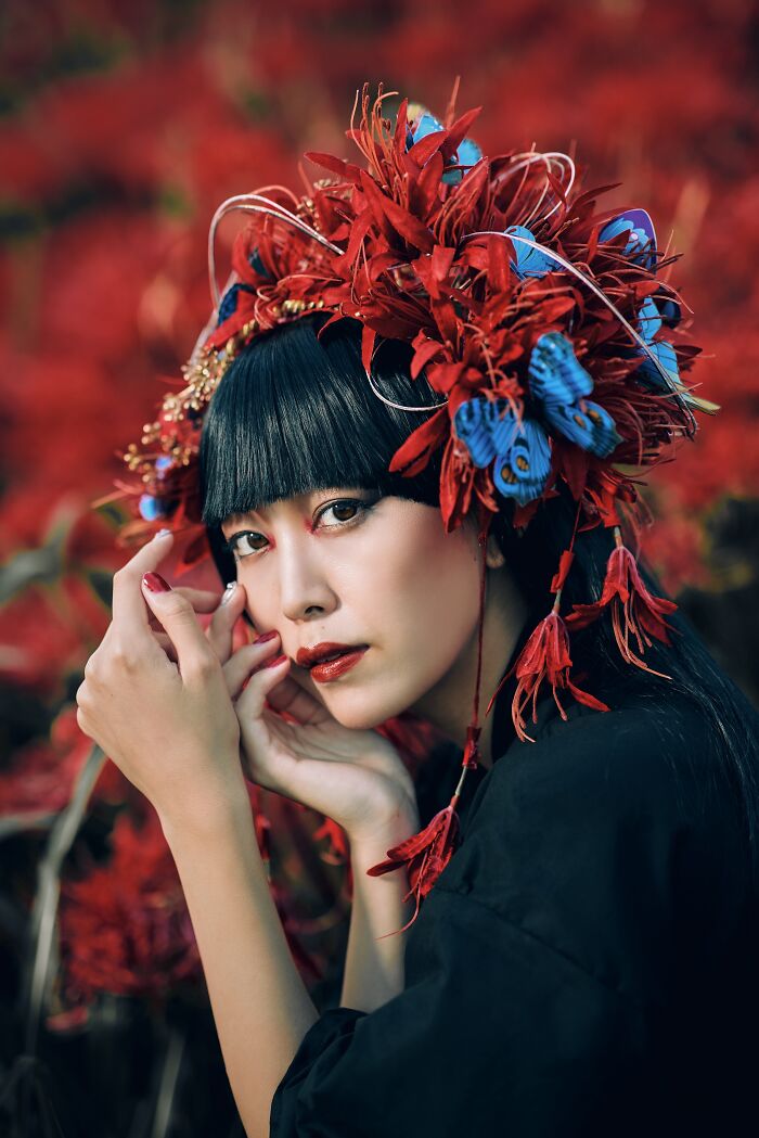 Woman with an elaborate red headdress in Budapest advertising photo award 2023.