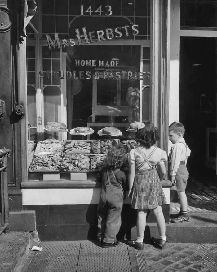 Three Children Stand Outside Mrs. Herbst's Bakery In New York City In 1960, Gazing Through The Window