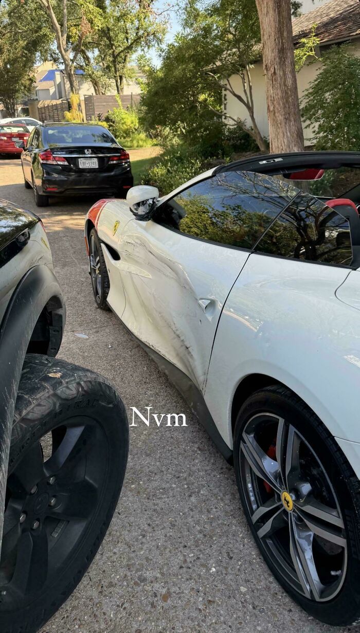 Damaged luxury car in driveway, showcasing an unfortunate incident that likely cost a fortune.