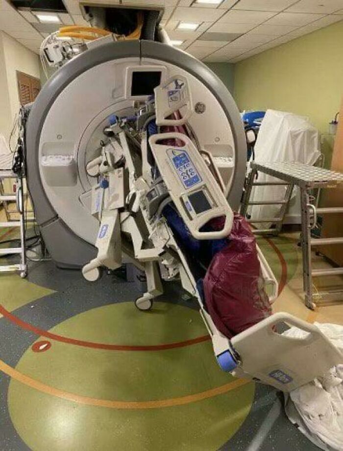 An MRI machine with an attached hospital bed, indicating an unfortunate and costly incident.