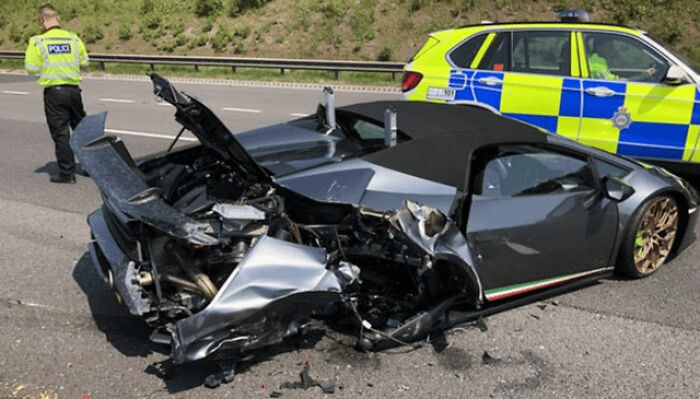 Luxury car in a costly accident with police presence on a highway.