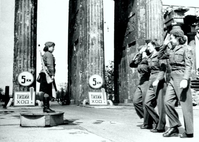 American Servicemen Salute A Soviet Traffic Controller At The Brandenburg Gate, Berlin, 1945