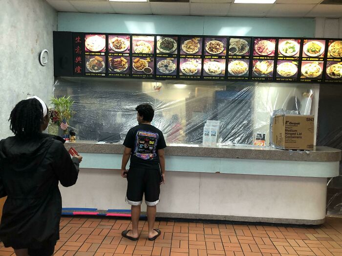 Local Chinese Restaurant. The Entire Kitchen Is Walled Off With Plastic. There’s A Cardboard Flap To Pass Money, And The Box On The Right Acts As An Airlock With Two Flaps To Pass The Food Through. It’s All Plastic Sheet, Cardboard And Duct Tape