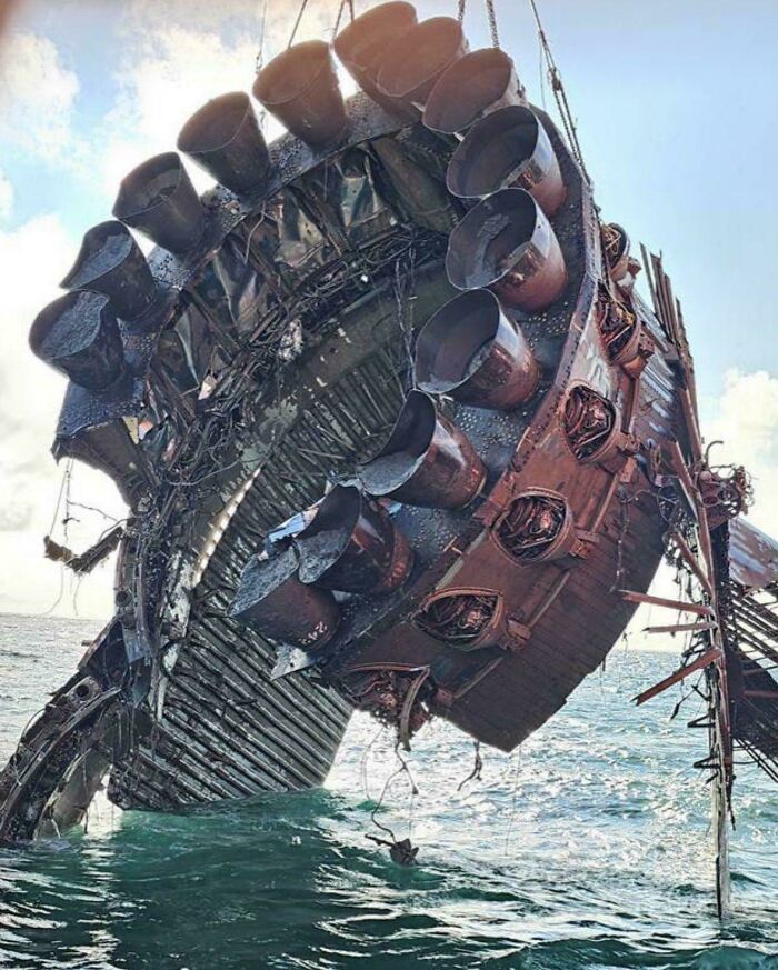 Rusty rocket debris being retrieved from the ocean, illustrating an unfortunate incident that likely cost a fortune.