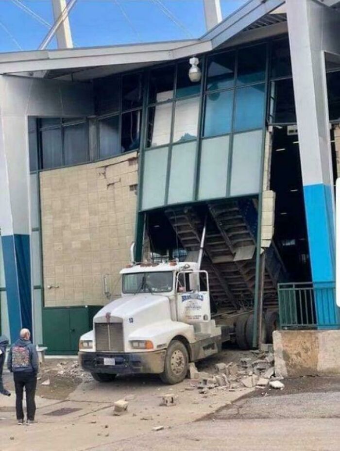 Truck crashes into building, causing expensive damage and a costly mess.