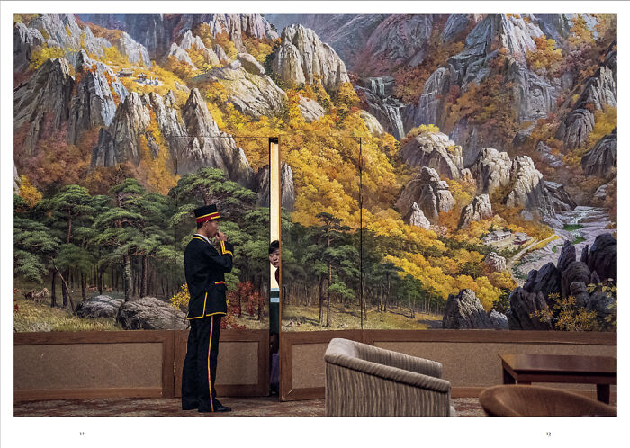 Man in uniform standing in front of a mural depicting mountains and forests, representing future photography trends.