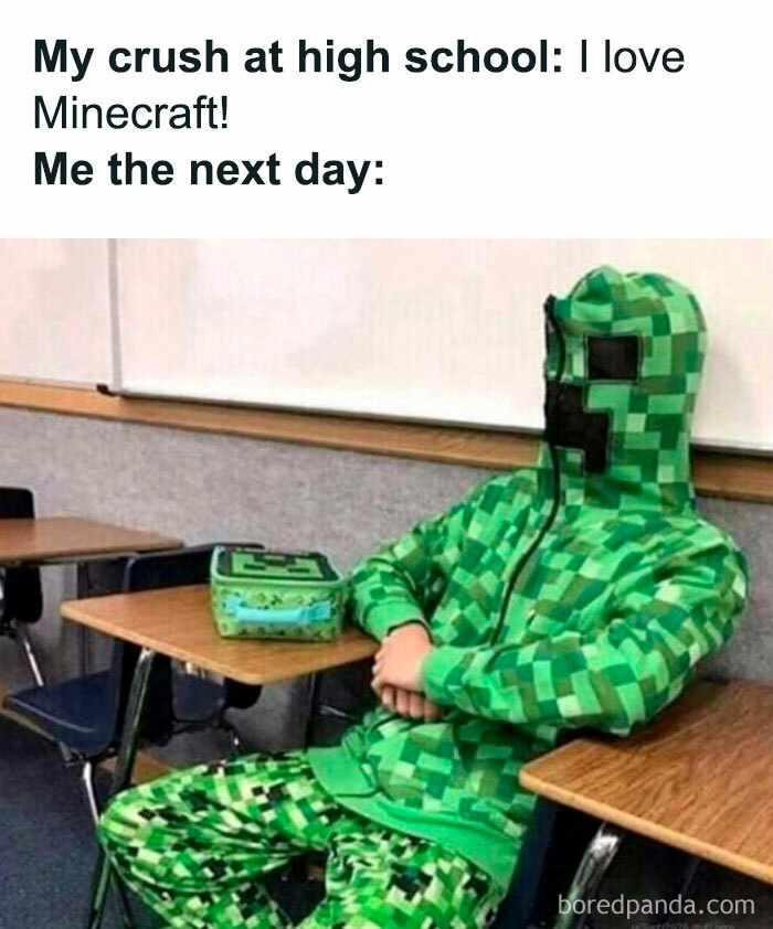 A Minecraft meme showing a humorous scenario where a student is sitting in a classroom wearing a full green Minecraft creeper outfit. The text above reads, "My crush at high school: I love Minecraft!" followed by "Me the next day:" as the image shows the person dressed in the creeper attire, implying they wore it to impress their crush by demonstrating their shared interest in Minecraft.