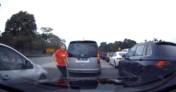 “Crazy” Woman Jumps In Front Of Vehicle So Her Husband Can Cut In Line