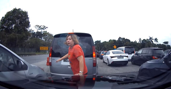 “Crazy” Woman Jumps In Front Of Vehicle So Her Husband Can Cut In Line