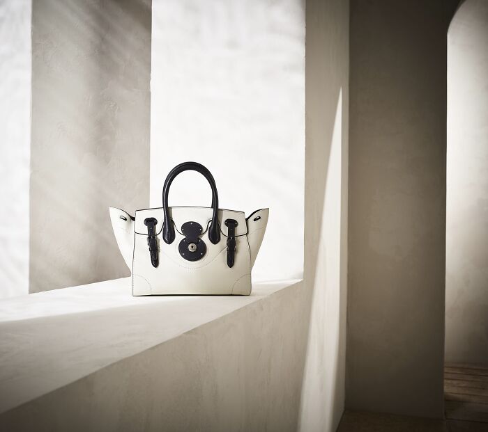 Elegant black-and-white handbag displayed in a minimalist setting, part of top 2023 advertising photos.