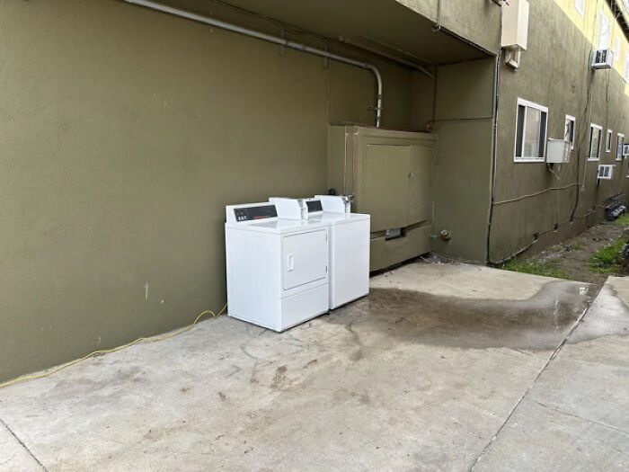 "Landlord is converting the common areas (parking and laundry) into additional units. Introducing the new “open air” laundry room. Powered by an extension cord and water just runs out into the grass" - fireman137