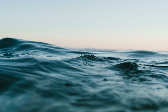 Close-up of ocean waves under a calm sky, capturing nature's beauty.