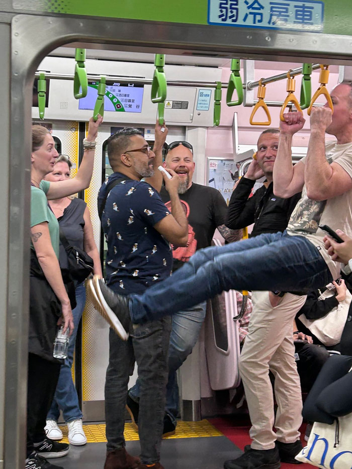 Tourist Showing Off His Gymnastics Skills In A Japanese Subway