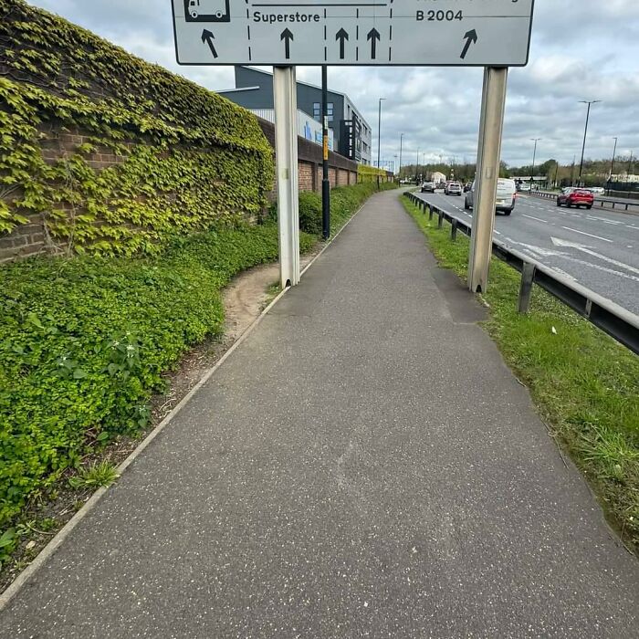 People Avoiding A UK Superstition - Walking Under Street Signs Is Bad Luck