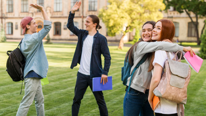 Students in a college campus setting, smiling and interacting, symbolizing youthful hope and college life experiences.