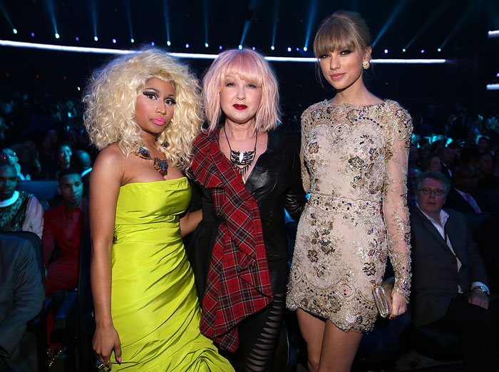 Taylor Swift in a beige embellished dress standing with Nicki Minaj in a bright green dress and Cyndi Lauper in a plaid scarf. How tall is Taylor Swift?