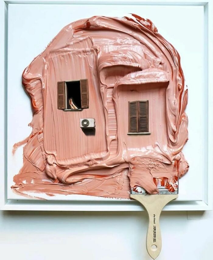 Surrealism art piece with a paintbrush creating a house facade featuring windows and shutters in pink paint.