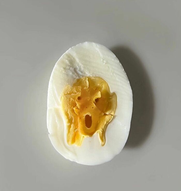 A surreal expression seen in a halved boiled egg, resembling a face.