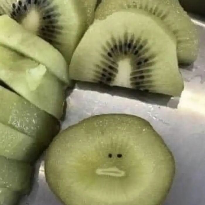 Sliced kiwi resembling a funny face, showcasing adorable and weird imagery for Instagram.