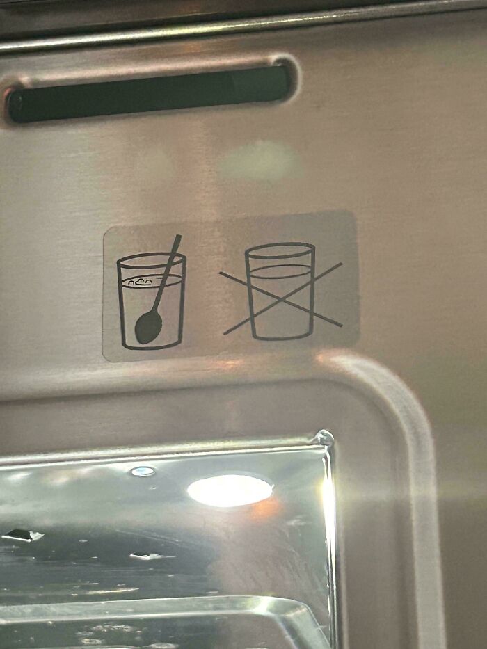 Dishwasher symbol showing correct placement of utensils in glasses. Mildly interesting detail spotted on a kitchen appliance.