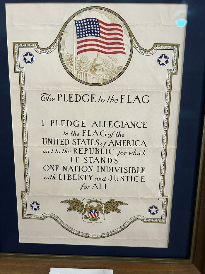 Vintage Pledge of Allegiance poster with American flag and Capitol illustration, showcasing mildly interesting historical design.